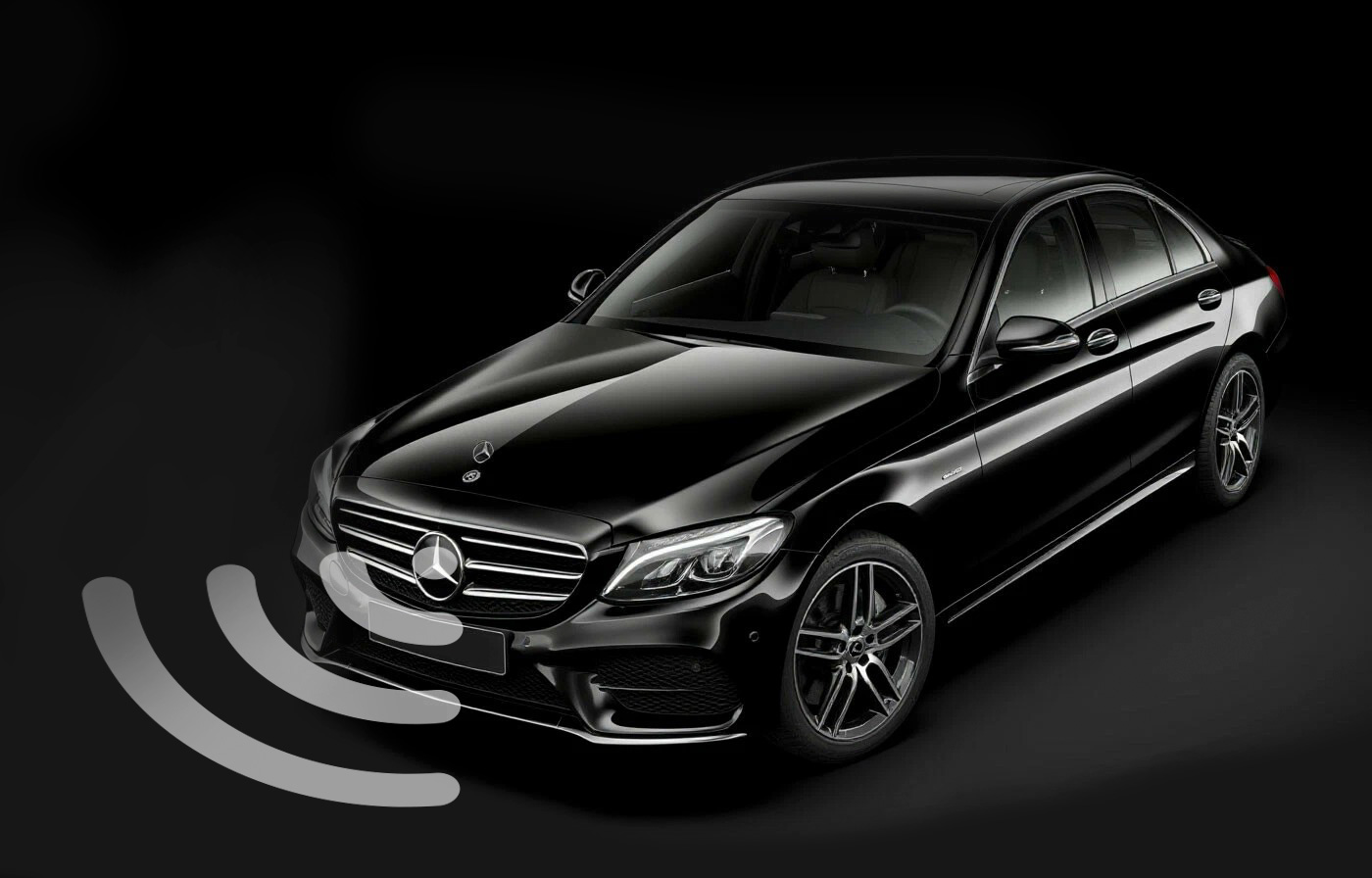 Mercedes-Benz sedan with the sensing arcs of its front radar and camera drawn ahead of the bumper